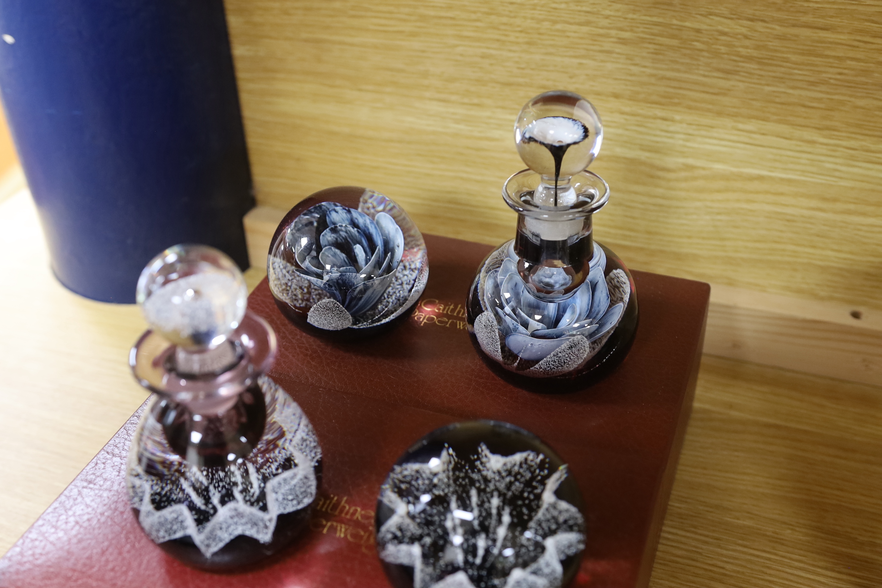 Caithness, three boxed sets comprising scent bottles and paperweights together with two Caithness Collector's Guides, each with boxes, limited editions, the largest 15cm high